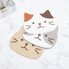 Calico, tabby and grey-and-white cat coasters fanned out on a marble surface
