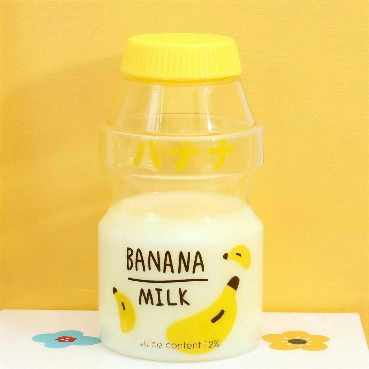 Clear banana fruit milk water bottle with yellow lid