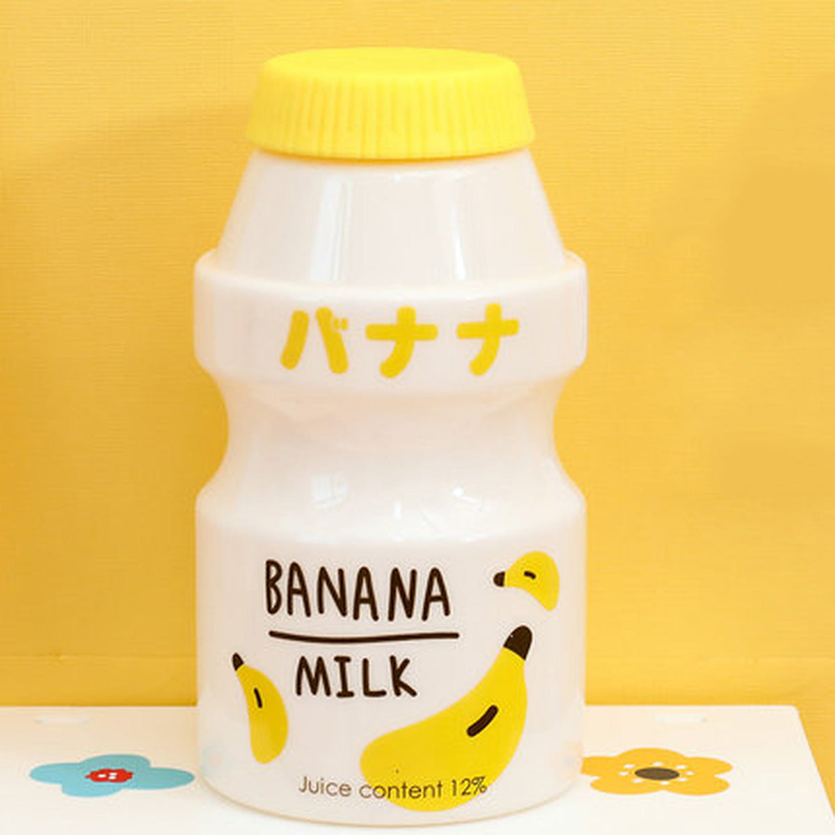 Opaque banana fruit milk water bottle with yellow lid
