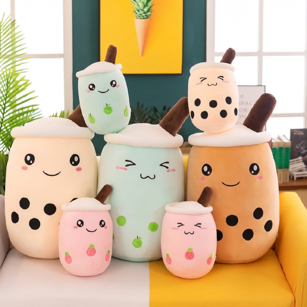 Boba Plush Pillows in six colors and sizes on a yellow sofa