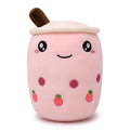 Boba Plush Pillow in pink with open eyes, a plush bubble-tea cup with a cream lid, straw, pearls and strawberry prints, on a white background