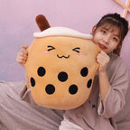 Model holding a brown Boba Plush Pillow with closed eyes