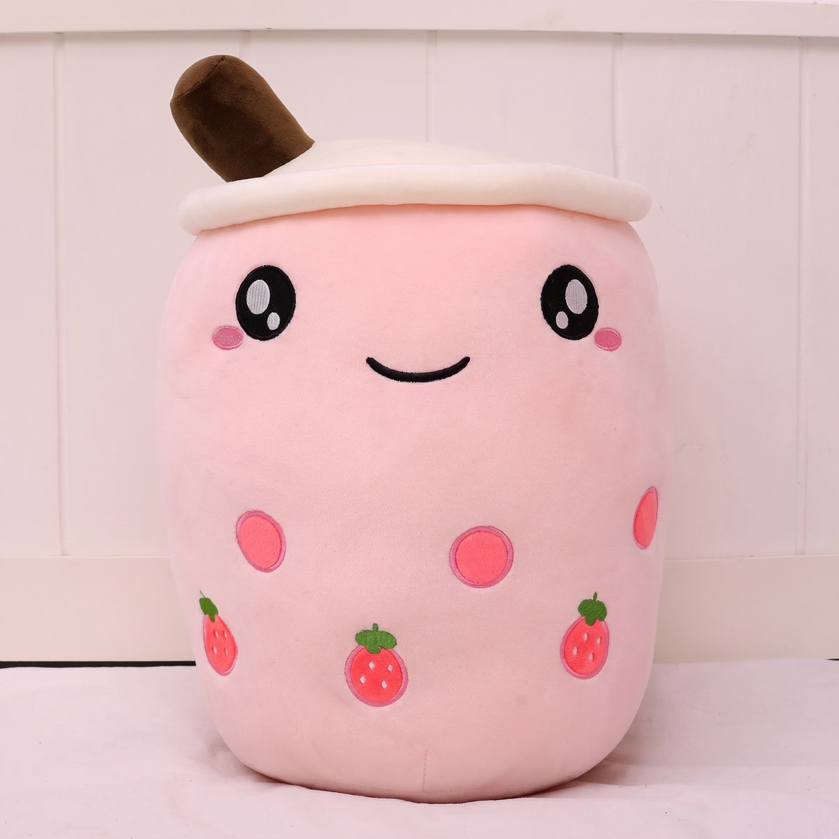 Boba Plush Pillow in pink with open eyes and strawberry prints, front view