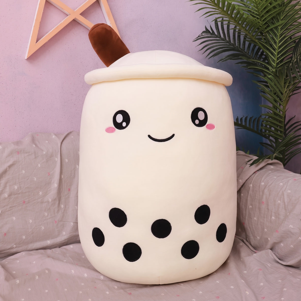 Boba Plush Pillow in white, wide open eyes and blushing cheeks, a plush bubble-tea cup with a cream lid, straw and pearls