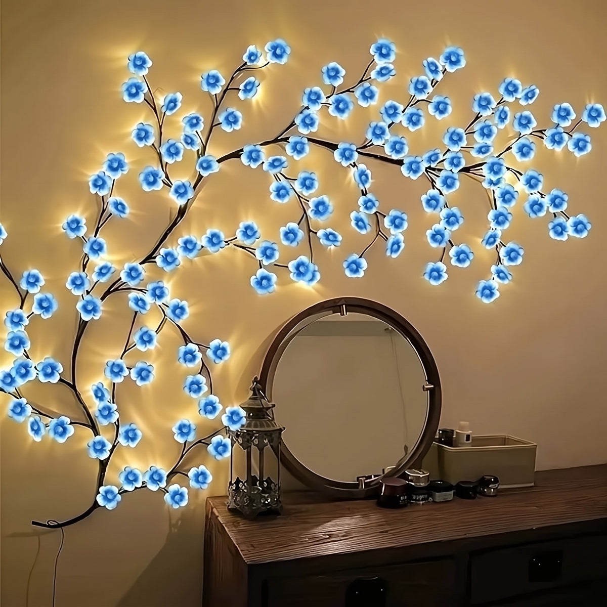 Blue Cherry Blossom Branch Light spreading across a wall above a dresser and round mirror