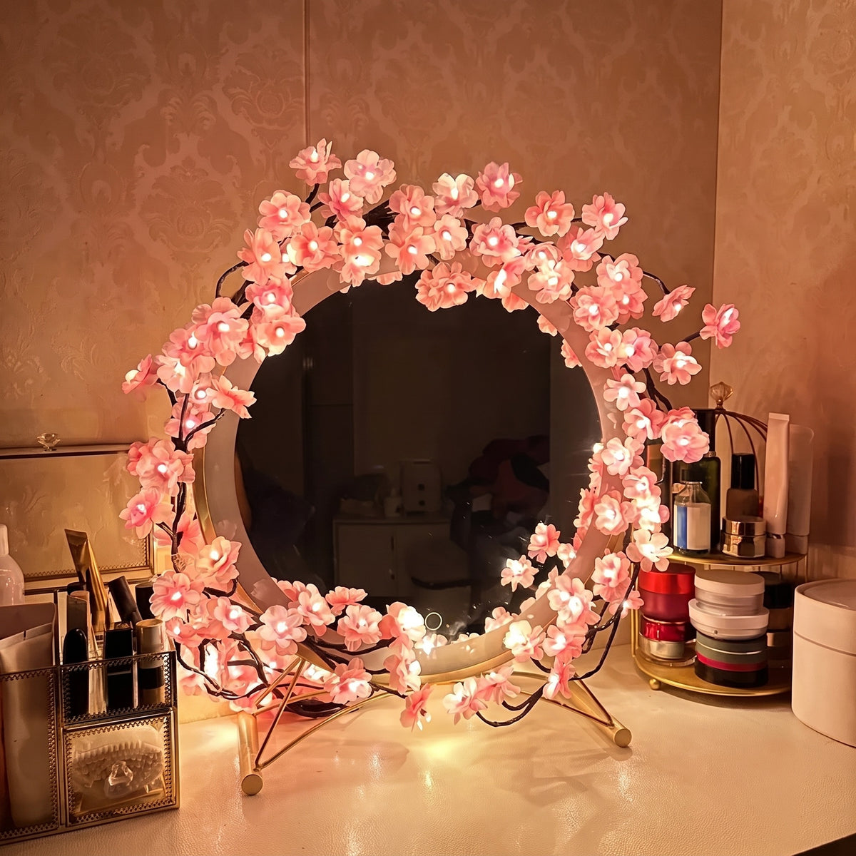 Pink Cherry Blossom Branch Light bent into a ring around a round vanity mirror