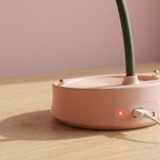 Back of the lamp base while charging: the included micro-USB cable in the DC 5V port, the ON/OFF switch, and the red charge indicator