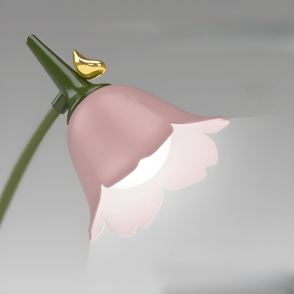Close-up of the lit flower-shaped lamp head with gold bird, showing the dimming glow