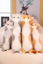 Long Cat Plush Pillows in grey and orange, four lengths standing side by side