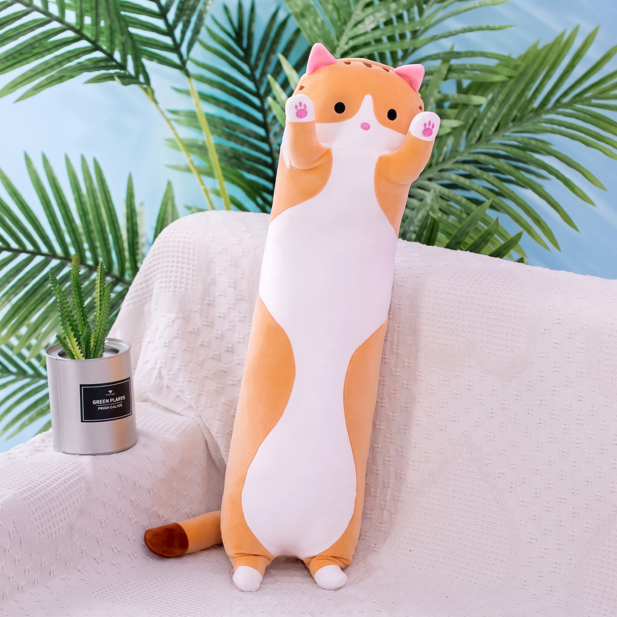 Long Cat Plush Pillow in orange tabby, a slim plush cat with a white belly and raised paws, standing on a sofa