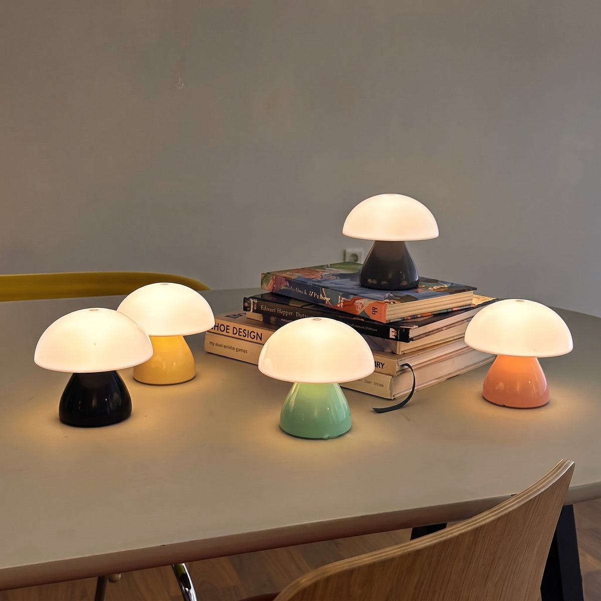 Five mini mushroom lamps lit on a table