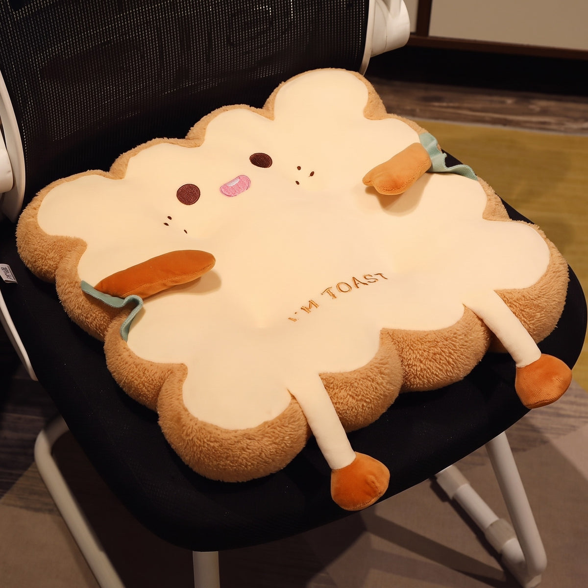 Toast Seat Cushion with the Cheeky face on a black office chair