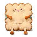 Toast Seat Cushion with the Cheeky face, a plush slice of toast with an embroidered face, small arms and dangling legs, on a white background