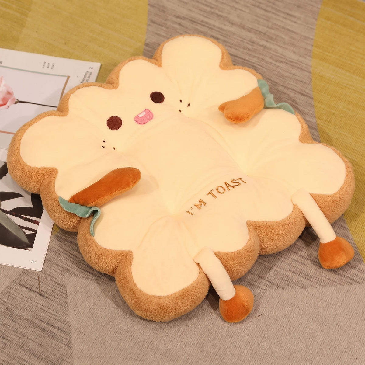 Toast Seat Cushion, Cheeky face with its tongue poking out, lying on a rug