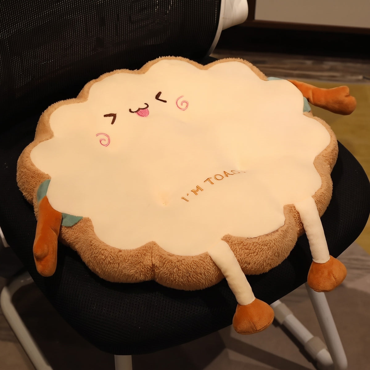 Toast Seat Cushion, Happy face with a closed-eye grin, on a black office chair